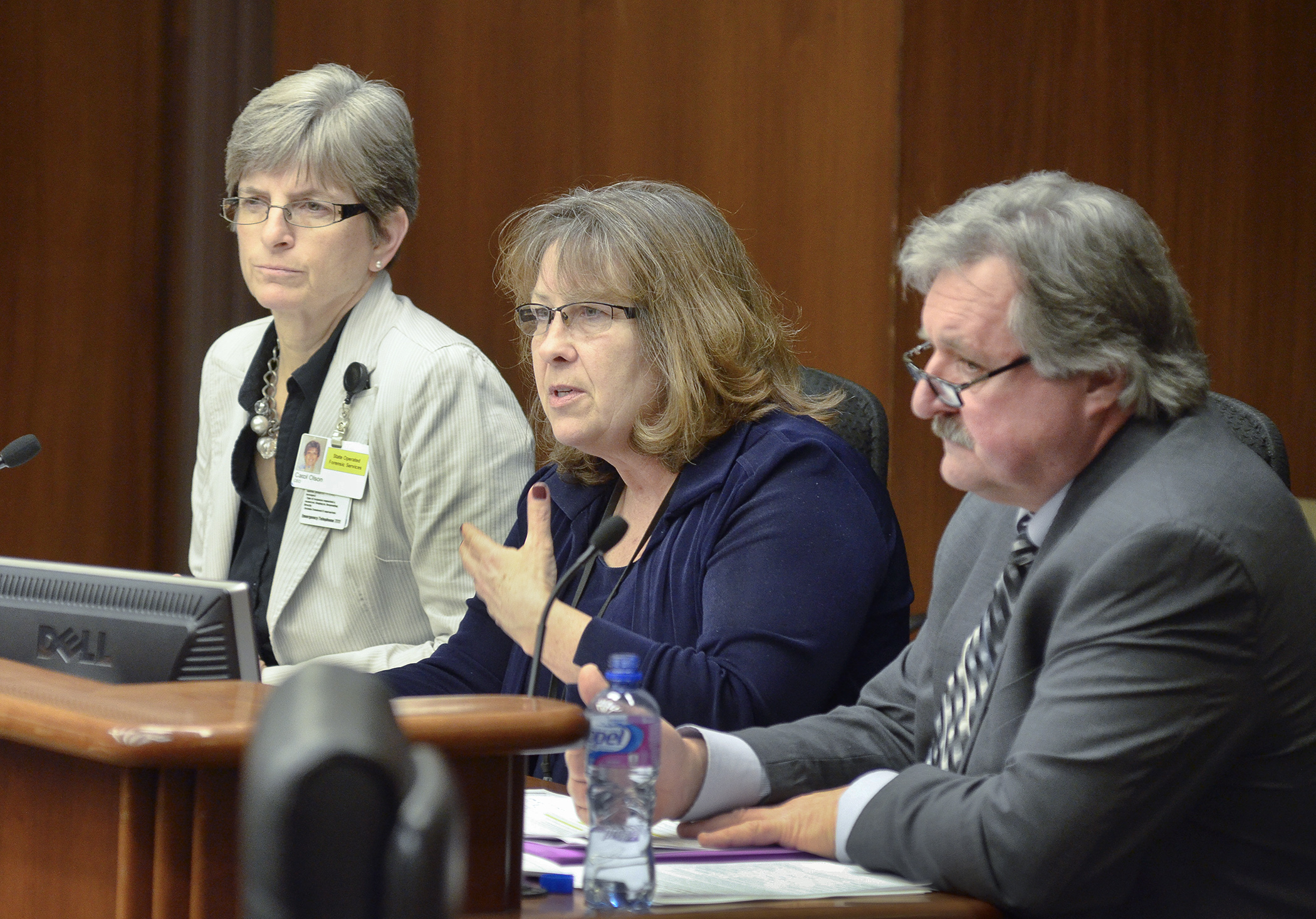 Carol Olson, from left, executive director of the Forensic Services Division, Department of Human Services Direct Care and Treatment Administration; Deputy Commissioner for Direct Care and Treatment Anne Barry; and Inspector General Jerry Kerber testify before the House Health and Human Services Finance Committee Jan. 20 during an overview of Minnesota Security Hospital Conditional License. Photo by Andrew VonBank